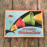 Stehauf - Hütchenspiel
